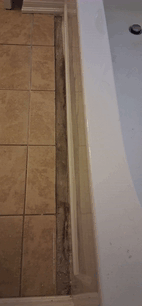 Bathroom floor tile repair near bathtub in Ottawa — FixItAll Handyman Services