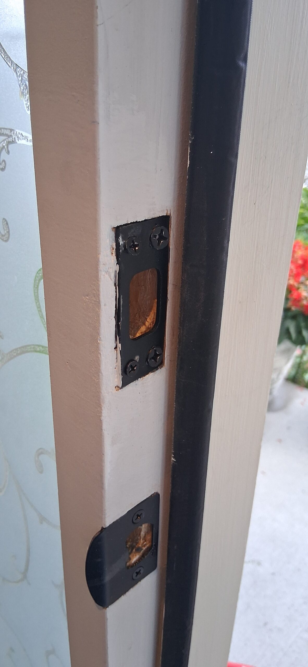 Door frame repair around strike plate area after fixing crack with epoxy wood filler and paint