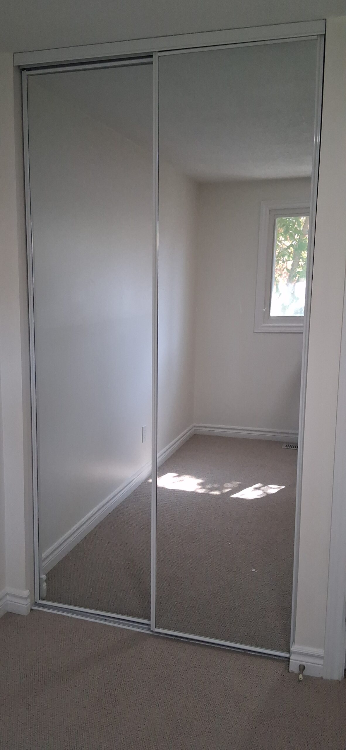 Closet installation with shelves, hanging rod, and sliding mirror doors in Ottawa — FixItAll Handyman Services