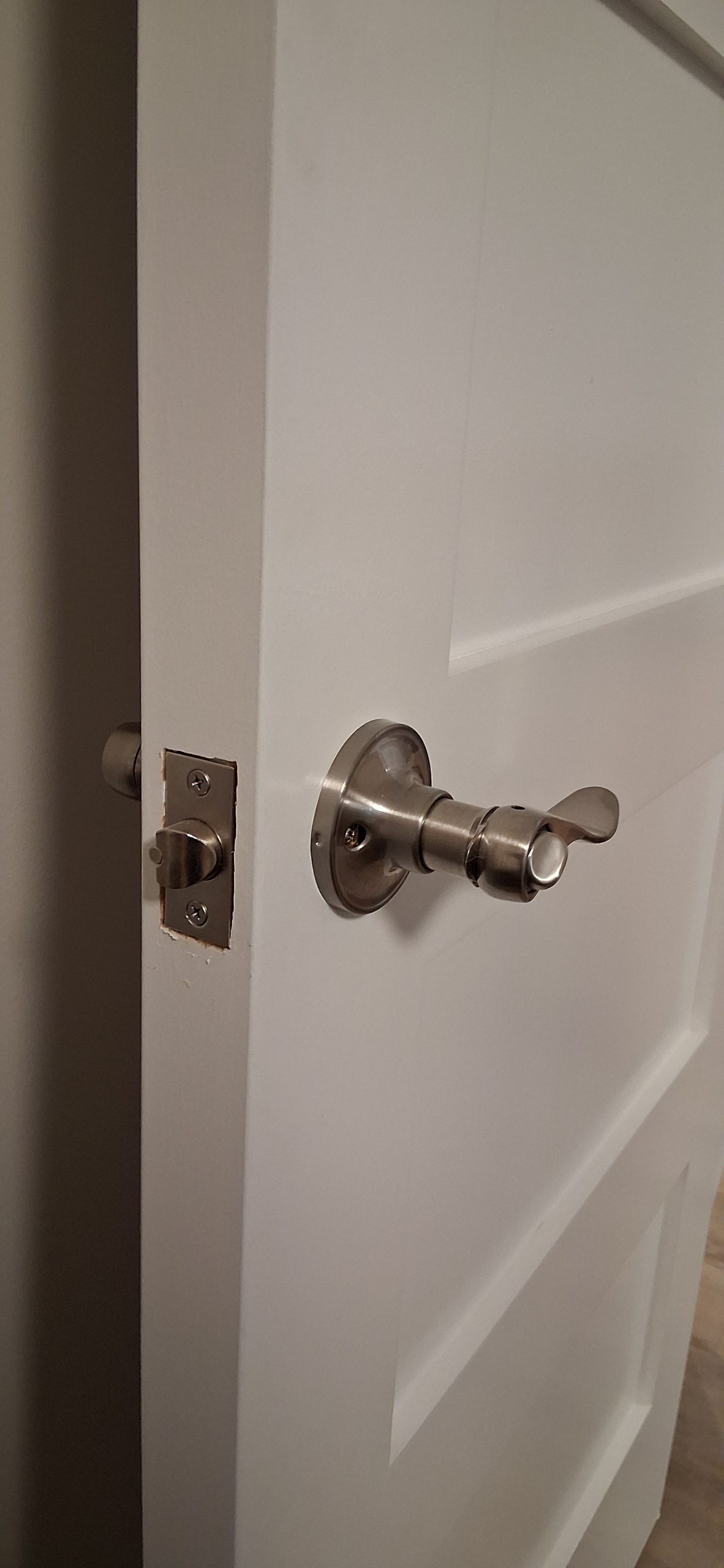 Handyman adjusting an interior door for smooth closing and proper latch alignment in Ottawa