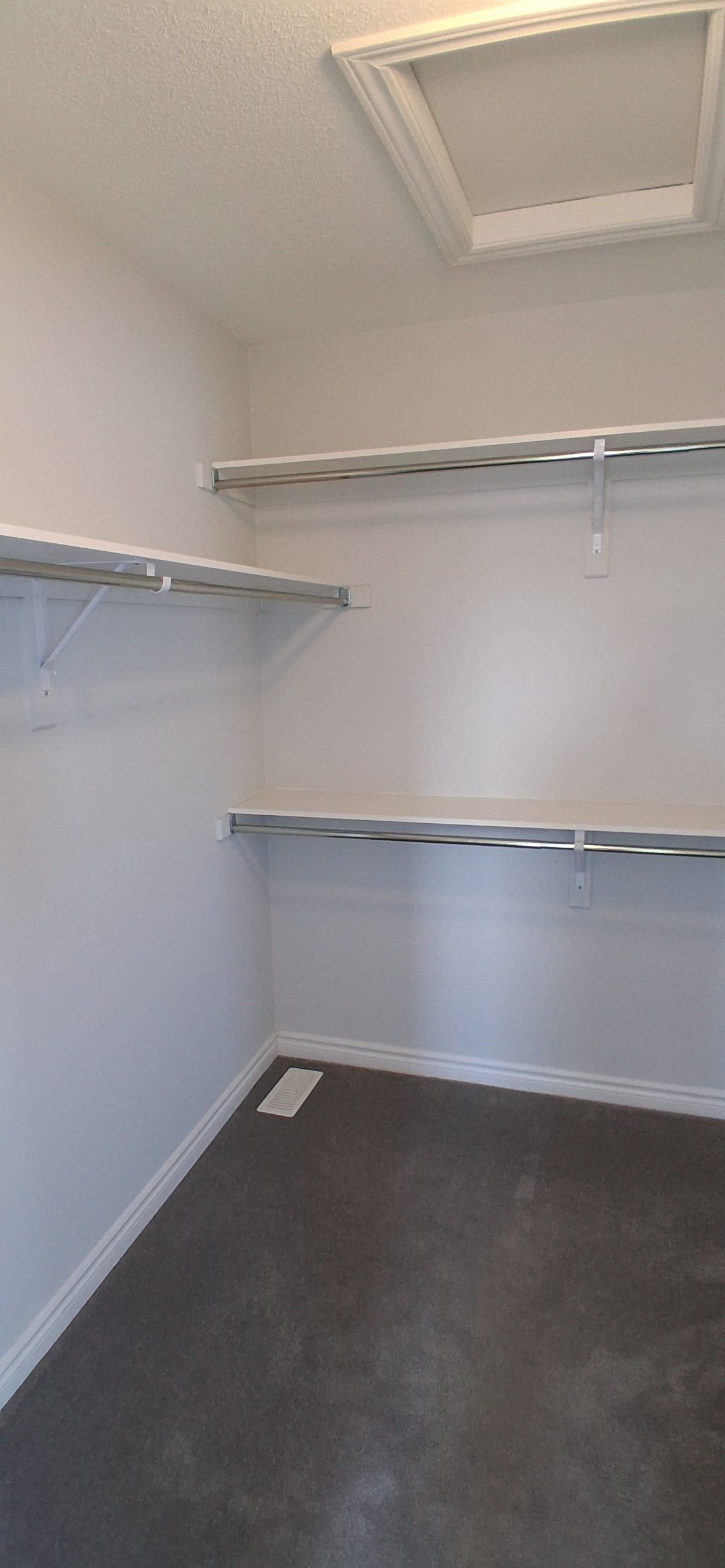 Wall shelf installation in Ottawa with a floating shelf being measured, levelled, and secured on an interior wall