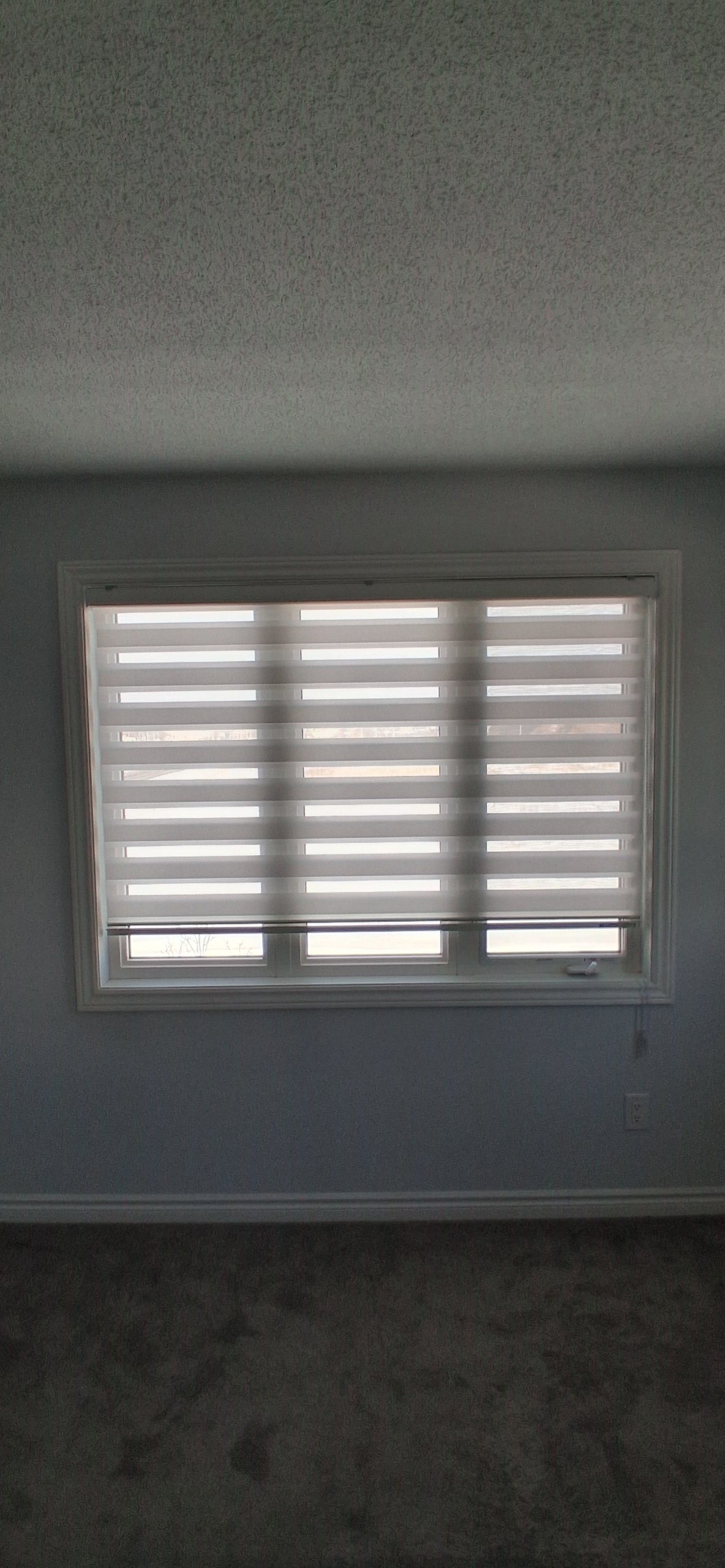 Blinds installation in Ottawa with window blinds being measured, aligned, and mounted neatly above an interior window