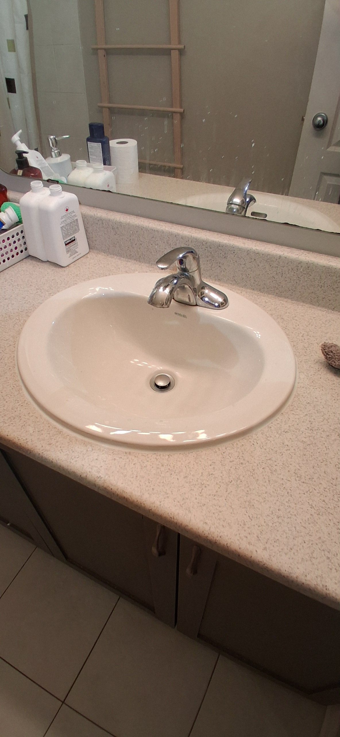 Old mouldy silicone removed and replaced with a fresh white seal along a bathroom wet-area joint in Ottawa.