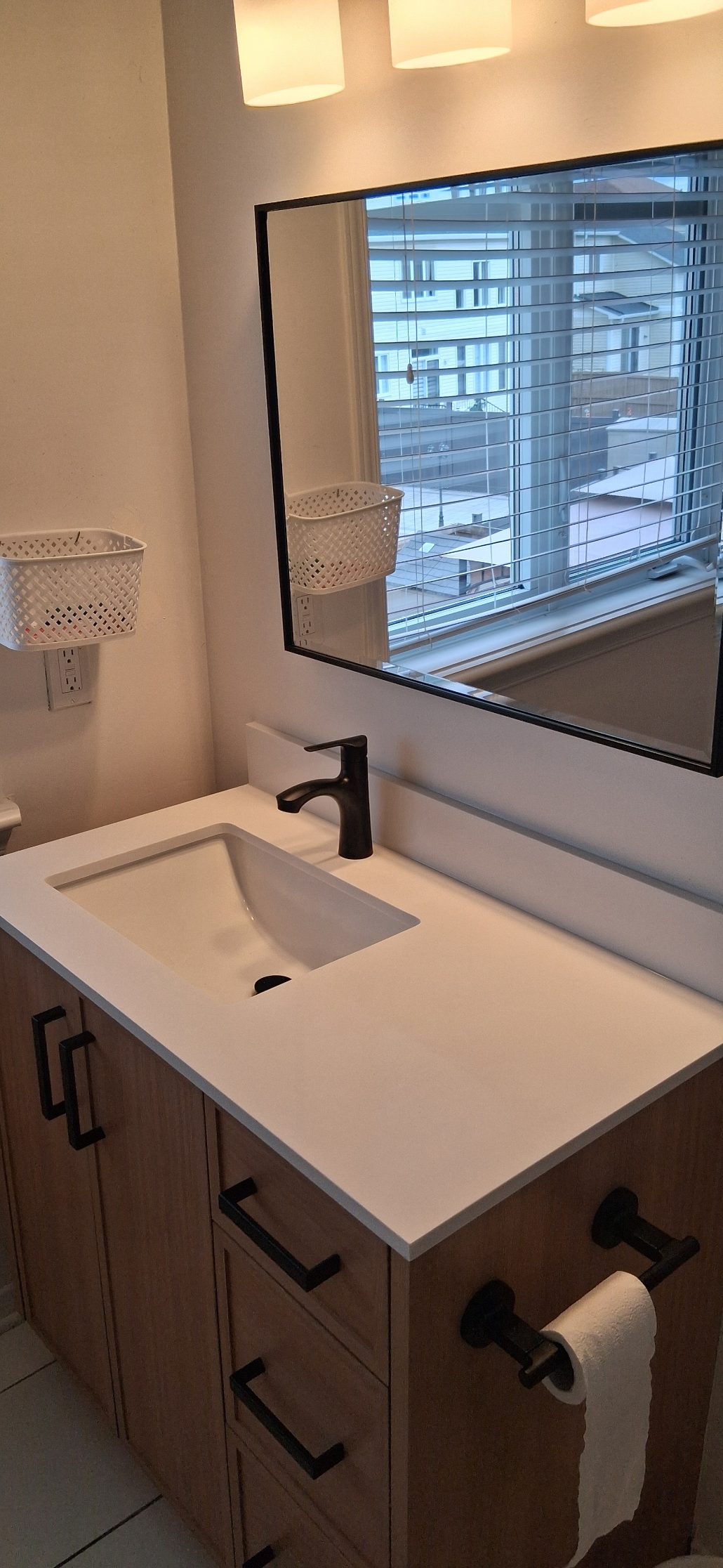 Fresh white caulking applied neatly between a sink and countertop edge in Ottawa after removal of worn sealant.