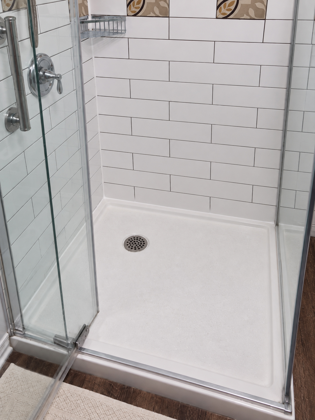 Shower base with clean, newly applied silicone caulking