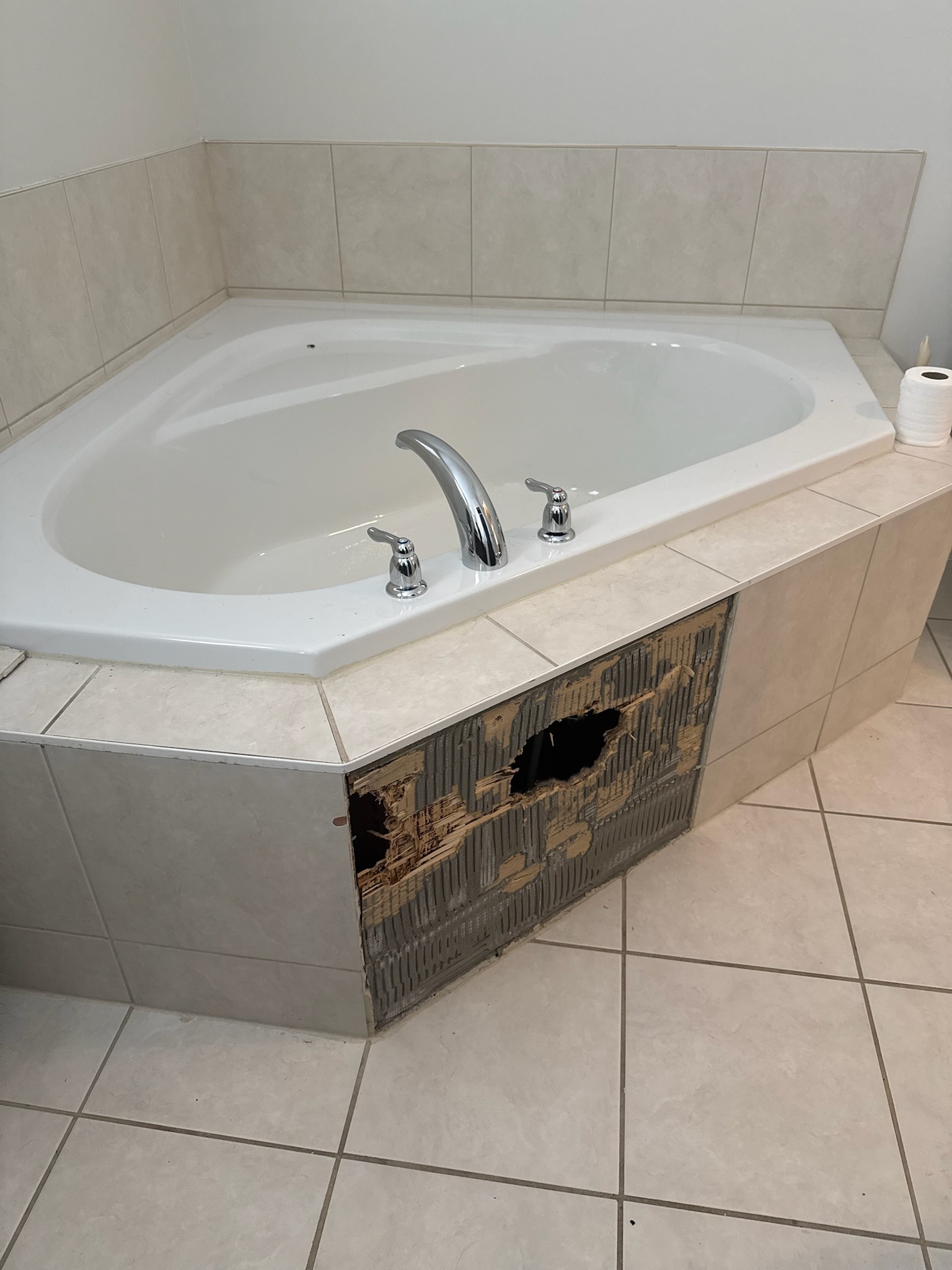 Damaged bathroom tiles before repair
