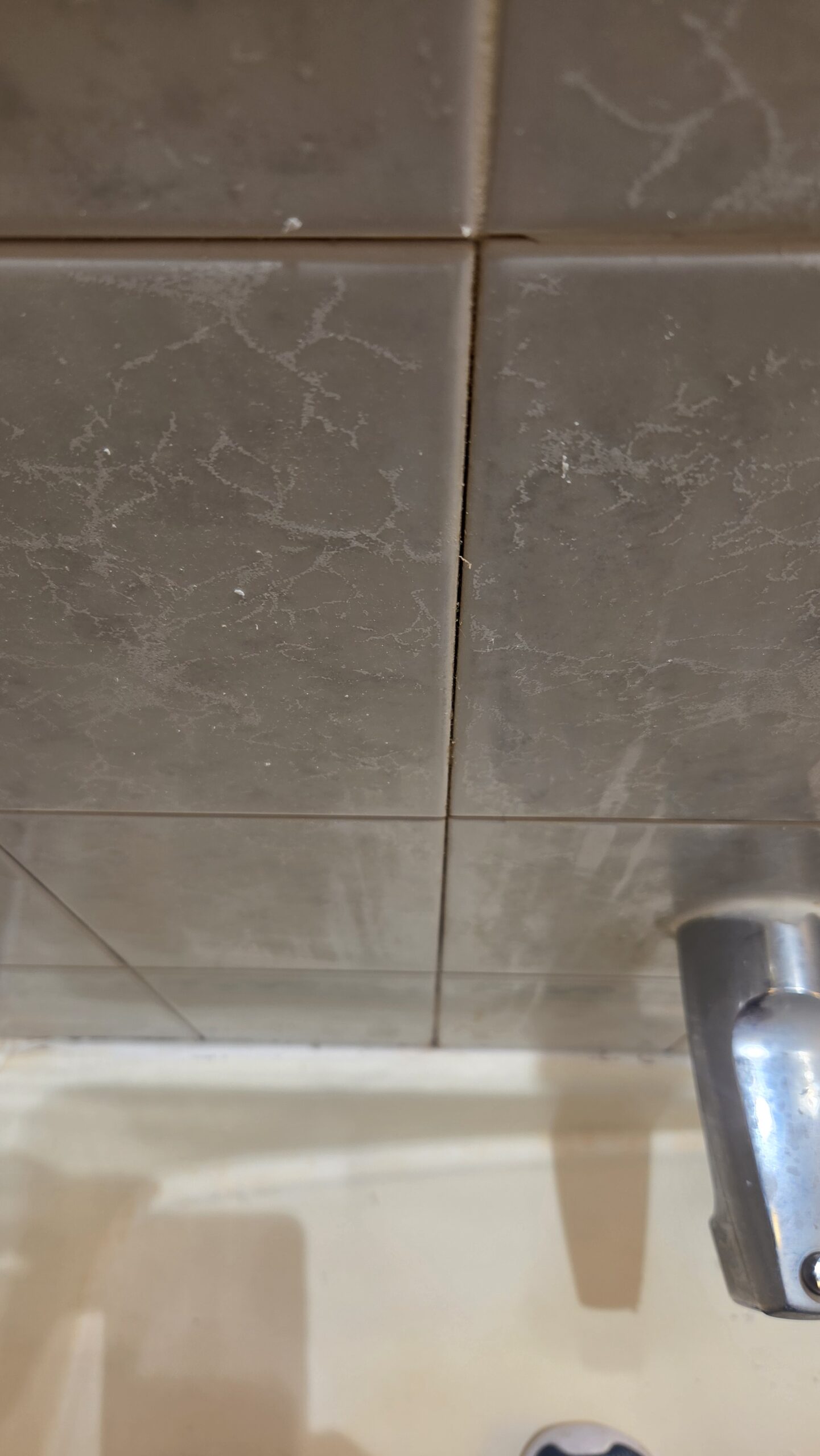 Cracked and deteriorated grout before repair