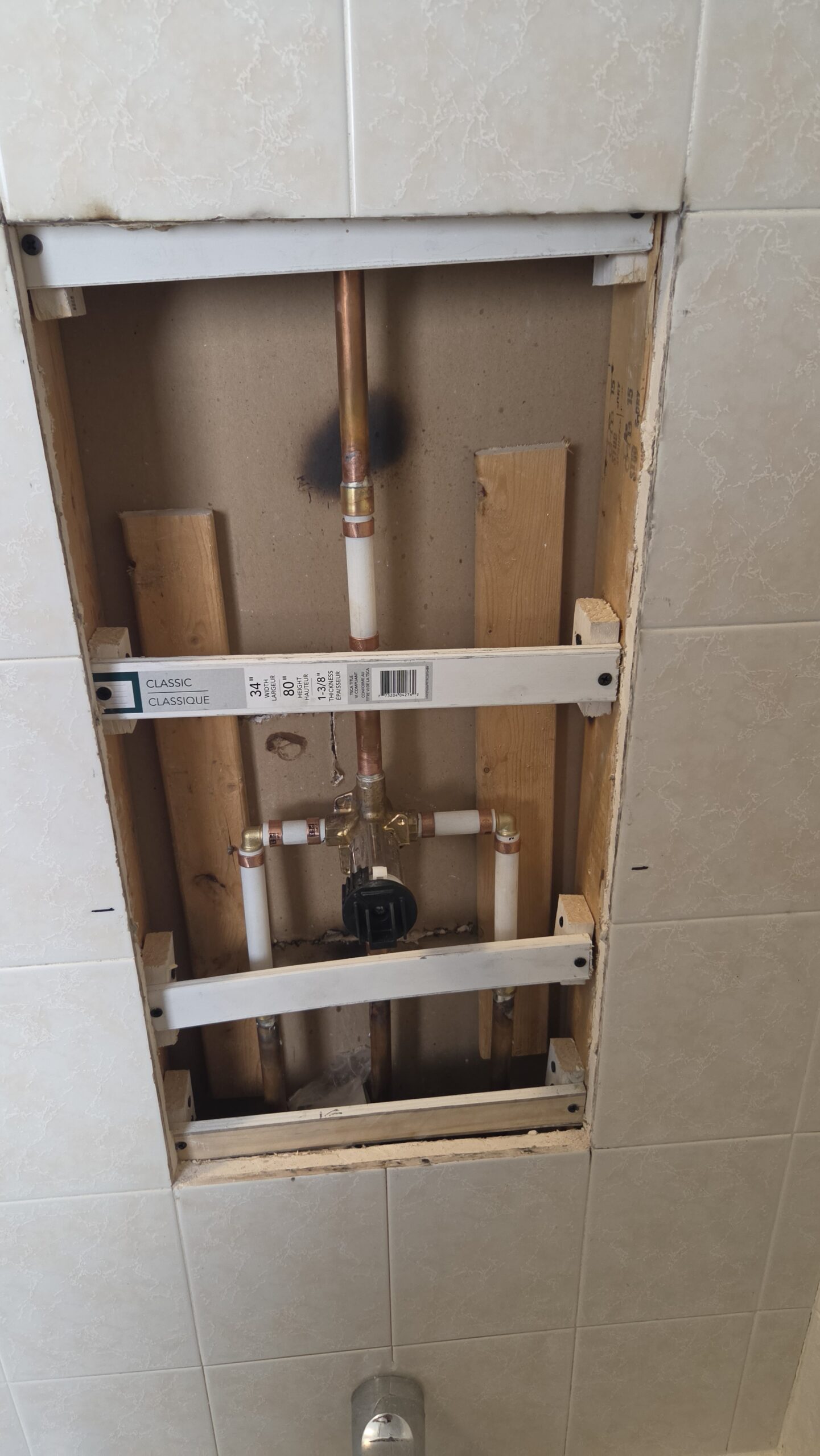Damaged shower tile before repair