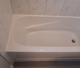 New bathtub caulking installed after removing worn sealant and preparing the joint. Fresh white caulking applied along a bathtub edge in Ottawa after old sealant removal and joint preparation.