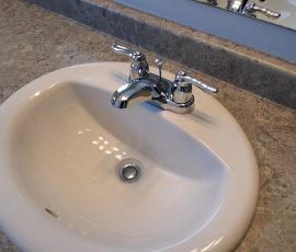 New caulking installed neatly along the sink and countertop joint after worn sealant removal. Fresh white caulking applied neatly between a sink and countertop edge in Ottawa after removal of worn sealant.